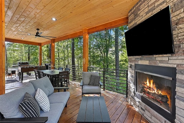 42 Hickory Ridge Rd, Broken Bow, OK 74728 - wooden terrace with an outdoor stone fireplace, outdoor dining space, and area for grilling