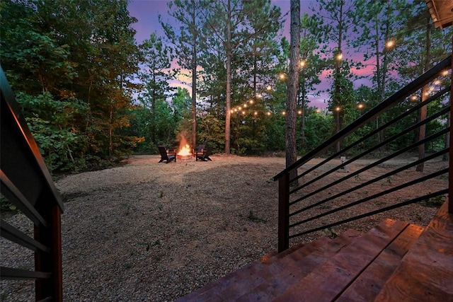 42 Hickory Ridge Rd, Broken Bow, OK 74728 - yard at dusk featuring a fire pit and stairs