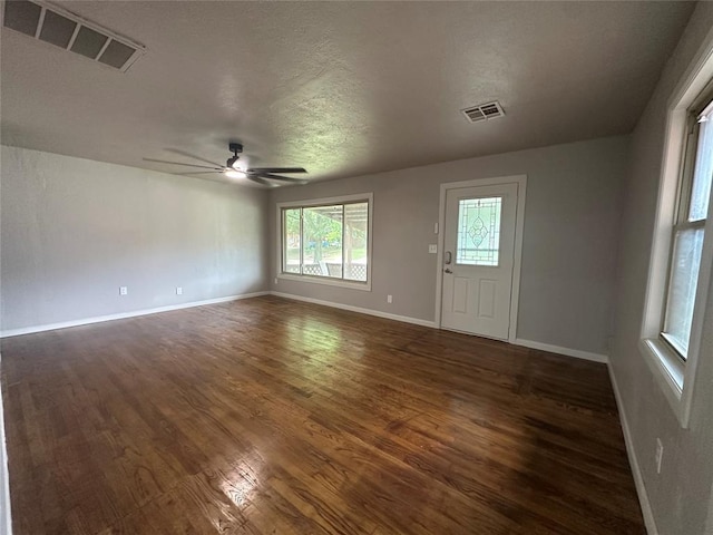 112 Burk Way, Del City, OK 73115 - empty room with wood finished floors, ceiling fan, and a textured ceiling