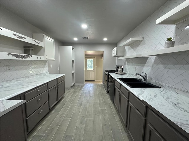 112 Burk Way, Del City, OK 73115 - kitchen with open shelves, decorative backsplash, black appliances, light stone counters, and recessed lighting