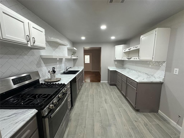 112 Burk Way, Del City, OK 73115 - kitchen featuring gas range, open shelves, light wood-style floors, light stone counters, and recessed lighting