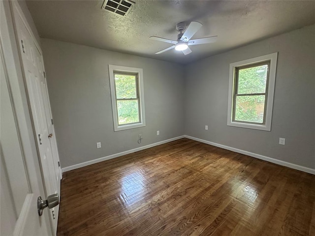 112 Burk Way, Del City, OK 73115 - unfurnished bedroom with wood finished floors, a ceiling fan, and a textured ceiling