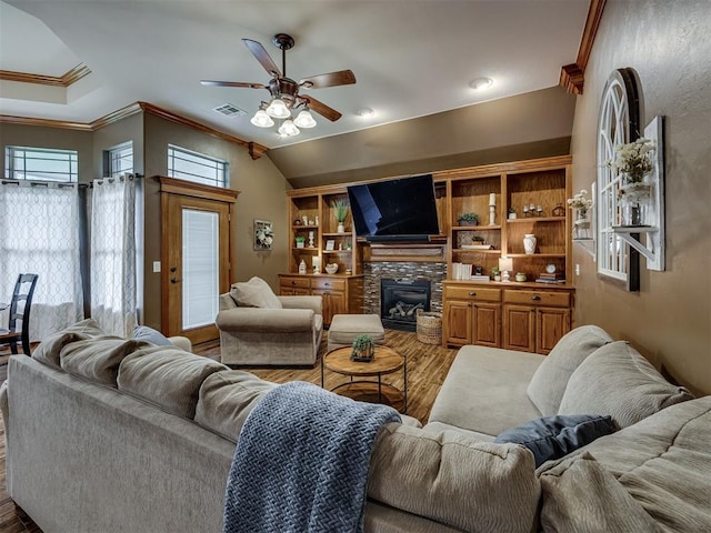 2108 Mulberry Creek Ave, Yukon, OK 73099 - living area with wood finished floors, crown molding, ceiling fan, and a fireplace