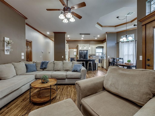 2108 Mulberry Creek Ave, Yukon, OK 73099 - living room featuring ornamental molding, light wood-style floors, ceiling fan, a chandelier, and recessed lighting