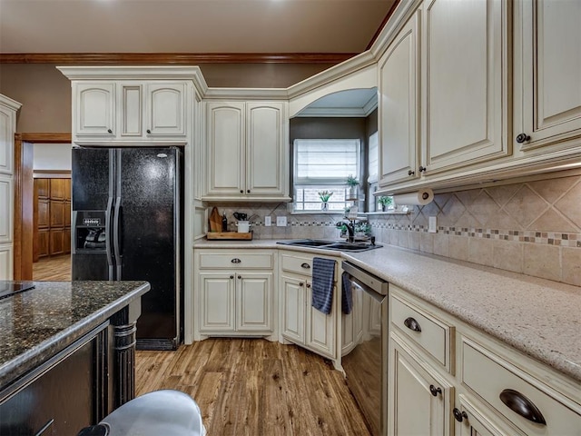 2108 Mulberry Creek Ave, Yukon, OK 73099 - kitchen featuring black fridge, cream cabinetry, dishwasher, light wood-style flooring, and crown molding
