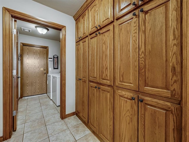 2108 Mulberry Creek Ave, Yukon, OK 73099 - corridor with washer and dryer and light tile patterned floors