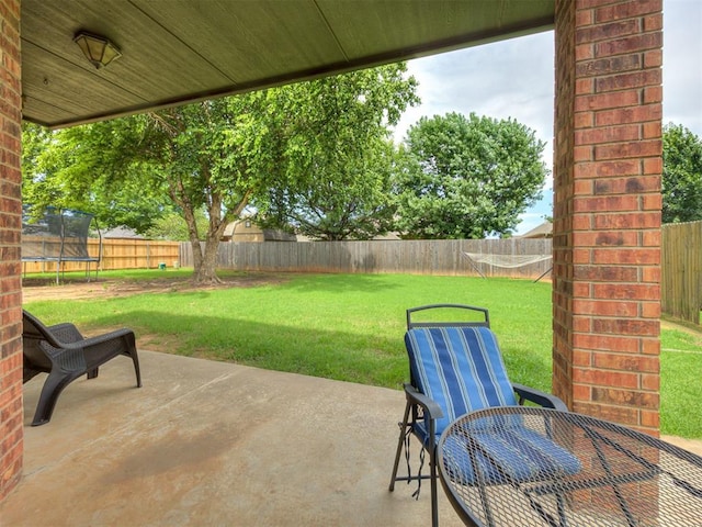 2108 Mulberry Creek Ave, Yukon, OK 73099 - fenced backyard featuring a trampoline and a patio