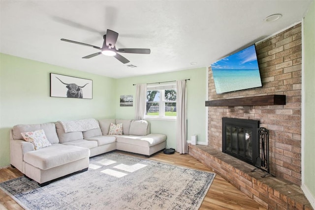 870 S Cemetery Rd Unit 2940, Tuttle, OK 73089 - living area with wood finished floors, a ceiling fan, and a brick fireplace