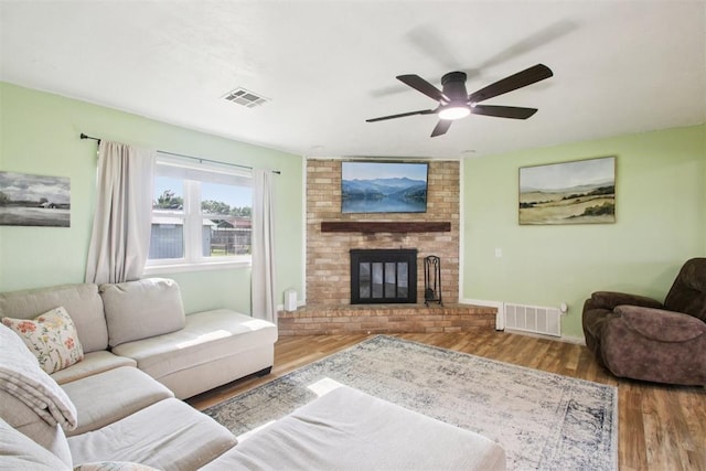 870 S Cemetery Rd Unit 2940, Tuttle, OK 73089 - living area featuring ceiling fan, wood finished floors, and a brick fireplace