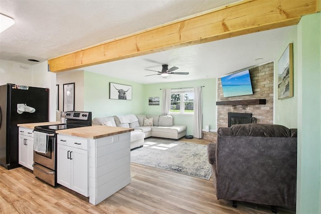 870 S Cemetery Rd Unit 2940, Tuttle, OK 73089 - kitchen featuring stainless steel electric range oven, wood counters, light wood-style floors, white cabinetry, and a textured ceiling