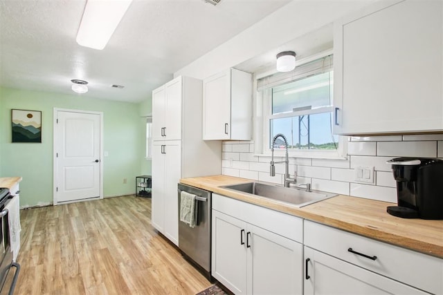 870 S Cemetery Rd Unit 2940, Tuttle, OK 73089 - kitchen with stainless steel appliances, wooden counters, decorative backsplash, light wood-style flooring, and white cabinetry