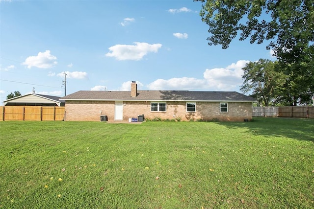 870 S Cemetery Rd Unit 2940, Tuttle, OK 73089 - rear view of house with a chimney, a fenced backyard, and brick siding