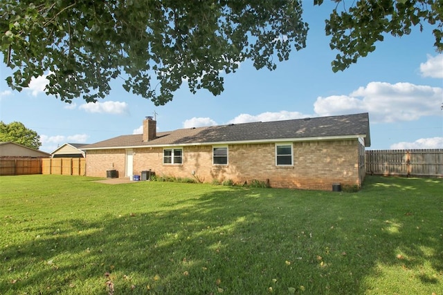 870 S Cemetery Rd Unit 2940, Tuttle, OK 73089 - back of property featuring brick siding, a chimney, and a fenced backyard