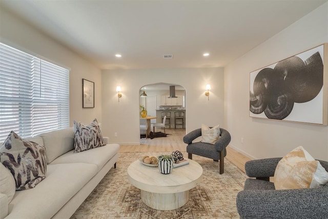 1109 NE 17th St, Oklahoma City, OK 73111 - living room featuring arched walkways, light wood finished floors, and recessed lighting