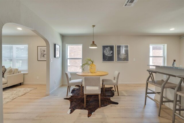 1109 NE 17th St, Oklahoma City, OK 73111 - dining area featuring arched walkways, light wood-style floors, and recessed lighting