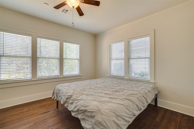 1134 NW 40th St, Oklahoma City, OK 73118 - bedroom with dark wood-type flooring, crown molding, and a ceiling fan