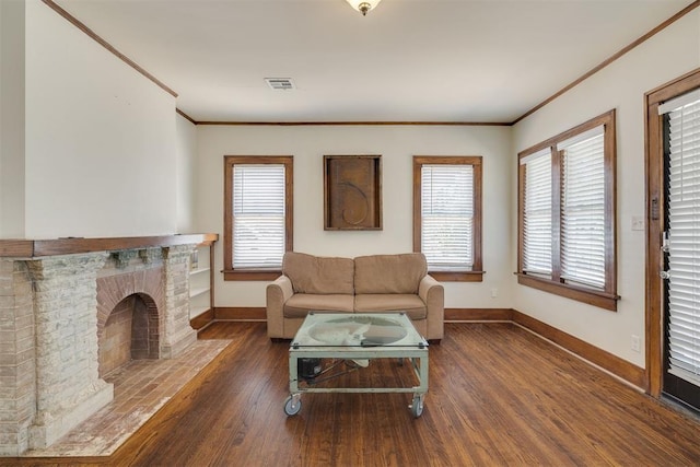1134 NW 40th St, Oklahoma City, OK 73118 - living room featuring crown molding, wood finished floors, plenty of natural light, and a brick fireplace