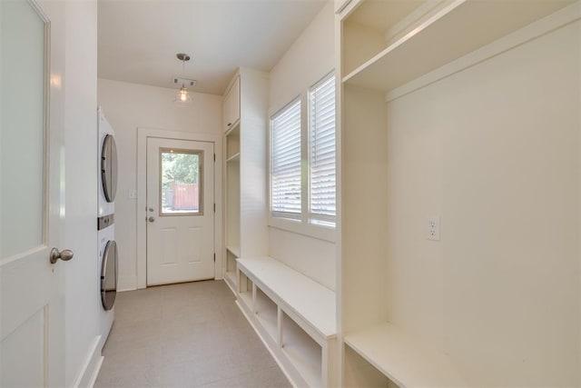 1134 NW 40th St, Oklahoma City, OK 73118 - mudroom with stacked washer and clothes dryer and light tile patterned floors