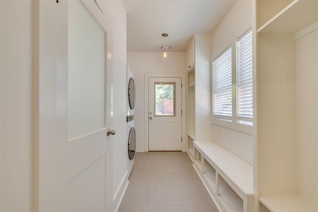 1134 NW 40th St, Oklahoma City, OK 73118 - washroom featuring estacked washer and dryer and light tile patterned floors