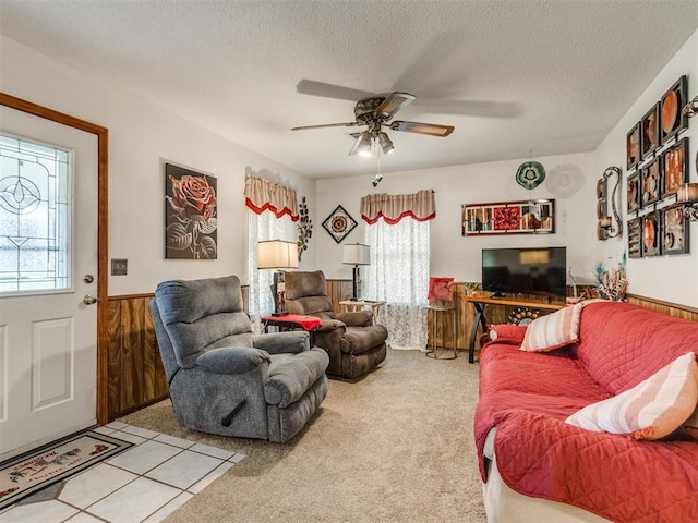 3900 Chetwood Dr, Del City, OK 73115 - living area with plenty of natural light, a ceiling fan, a textured ceiling, a wainscoted wall, and carpet flooring