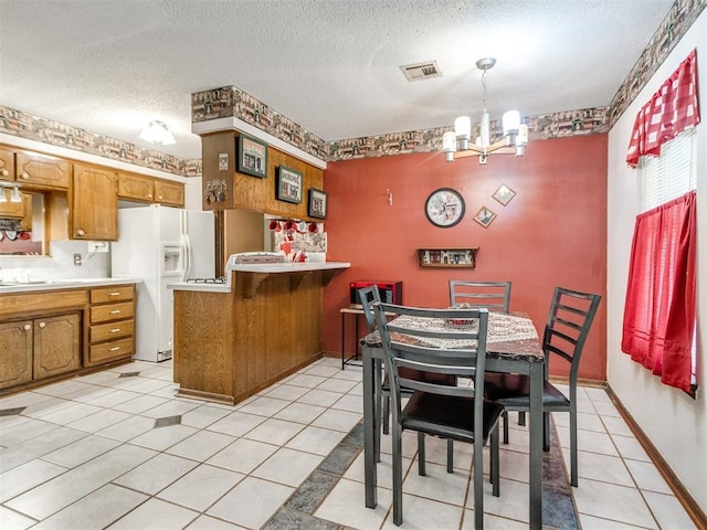 3900 Chetwood Dr, Del City, OK 73115 - dining area featuring a chandelier, a textured ceiling, and light tile patterned floors