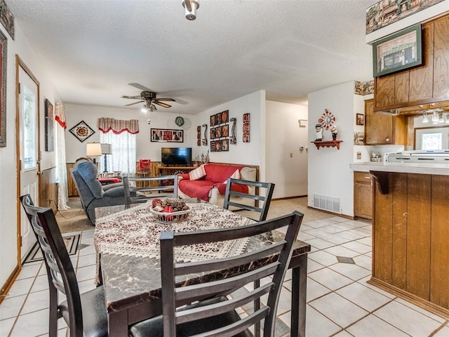 3900 Chetwood Dr, Del City, OK 73115 - dining space with a ceiling fan, a textured ceiling, and light tile patterned flooring