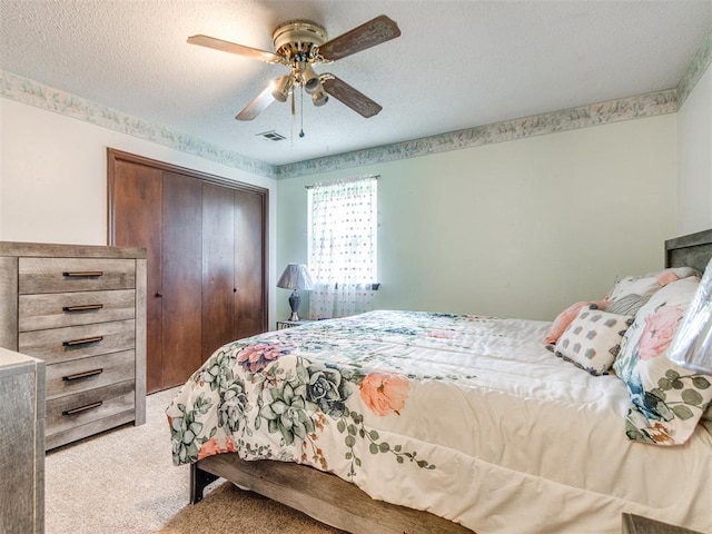 3900 Chetwood Dr, Del City, OK 73115 - bedroom with light carpet, a closet, a ceiling fan, and a textured ceiling