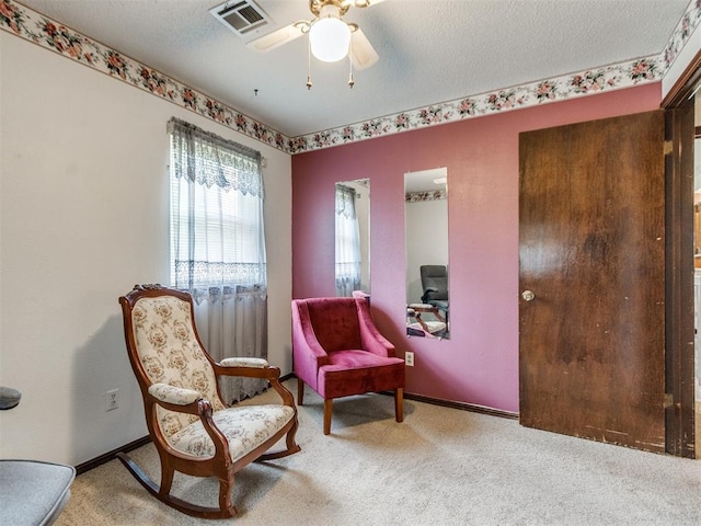 3900 Chetwood Dr, Del City, OK 73115 - sitting room featuring carpet floors, a ceiling fan, and a textured ceiling
