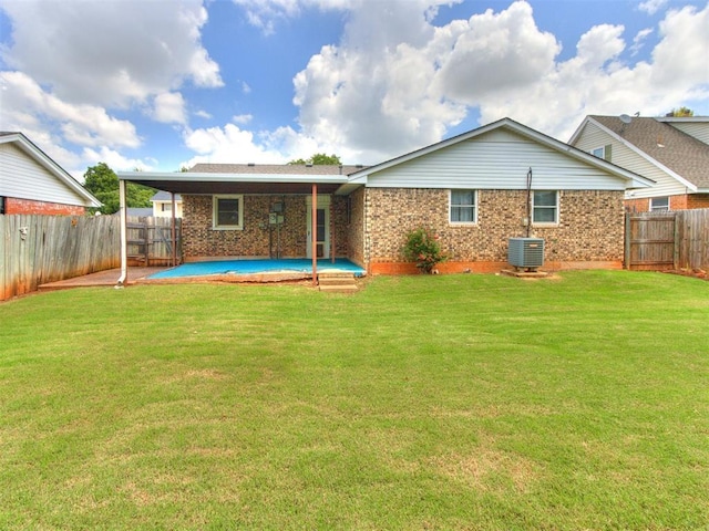 3900 Chetwood Dr, Del City, OK 73115 - back of property featuring a fenced backyard and brick siding