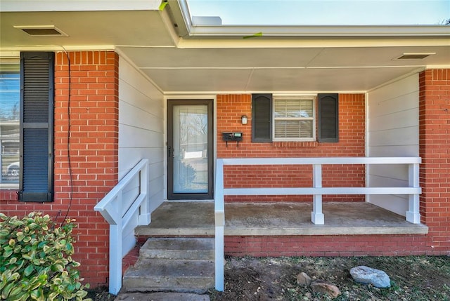 220 E 31st St, Edmond, OK 73013 - property entrance with a porch and brick siding