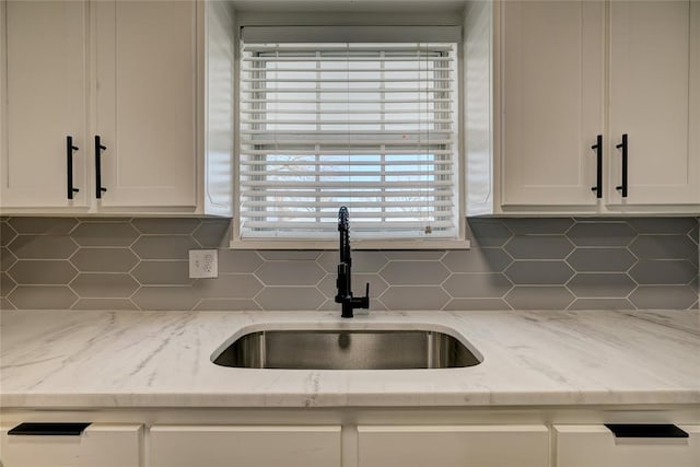 220 E 31st St, Edmond, OK 73013 - kitchen with backsplash, white cabinetry, and light stone countertops
