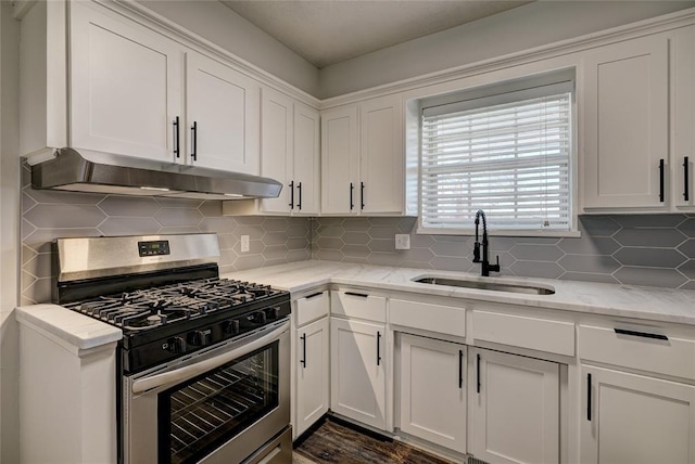 220 E 31st St, Edmond, OK 73013 - kitchen featuring stainless steel gas range oven, range hood, white cabinets, and decorative backsplash