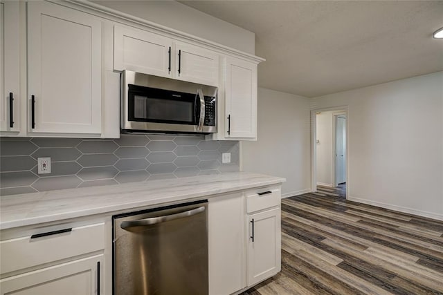 220 E 31st St, Edmond, OK 73013 - kitchen featuring stainless steel appliances, decorative backsplash, white cabinets, dark wood-style flooring, and light stone countertops