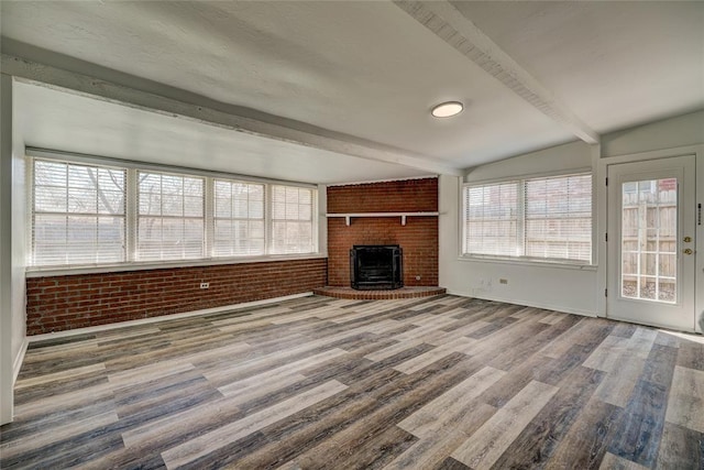 220 E 31st St, Edmond, OK 73013 - unfurnished living room with brick wall, a fireplace, and wood finished floors