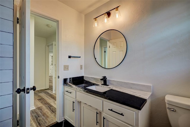 220 E 31st St, Edmond, OK 73013 - bathroom featuring wood finished floors and vanity
