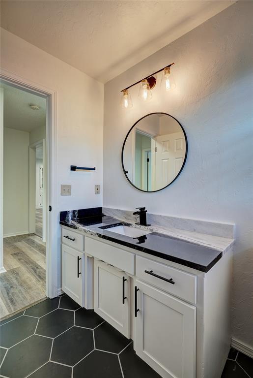 220 E 31st St, Edmond, OK 73013 - bathroom with vanity and tile patterned floors