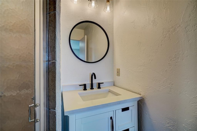 220 E 31st St, Edmond, OK 73013 - bathroom featuring vanity and a textured wall