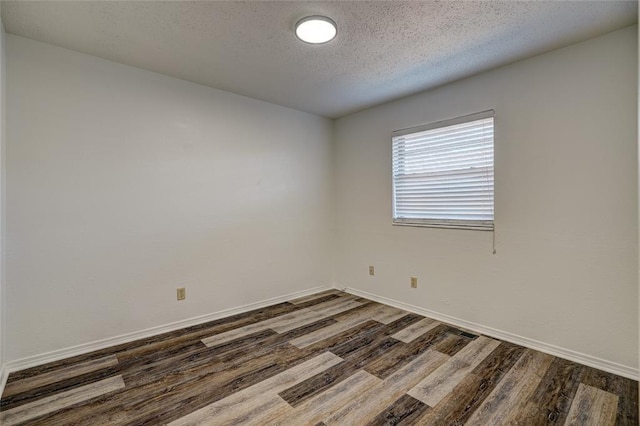 220 E 31st St, Edmond, OK 73013 - spare room with dark wood-type flooring and a textured ceiling