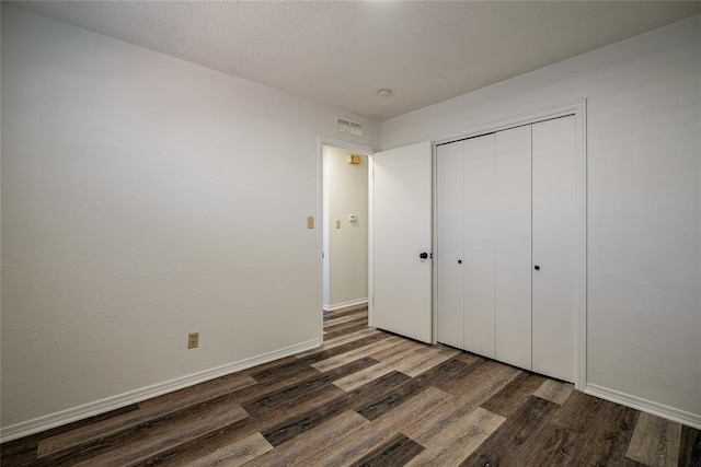 220 E 31st St, Edmond, OK 73013 - unfurnished bedroom with wood finished floors and a closet