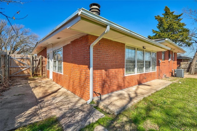 220 E 31st St, Edmond, OK 73013 - view of side of home with brick siding, a gate, and a patio