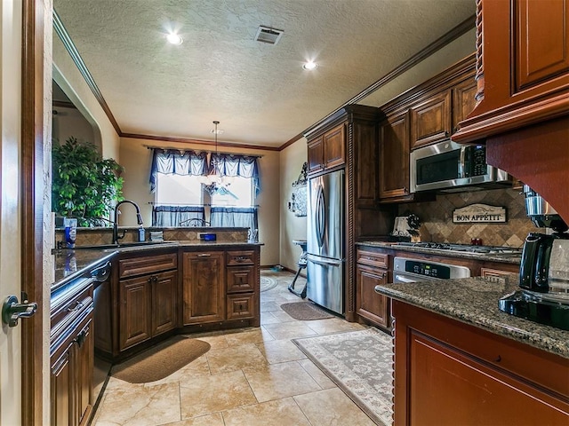 13120 NW 4th St, Yukon, OK 73099 - kitchen featuring appliances with stainless steel finishes, ornamental molding, backsplash, a textured ceiling, and dark stone counters