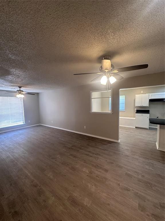 6708 Lyrewood Cir, Oklahoma City, OK 73132 - unfurnished living room featuring a ceiling fan, a textured ceiling, and dark wood-style floors