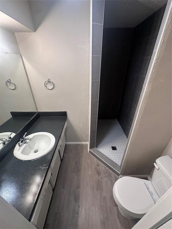 6708 Lyrewood Cir, Oklahoma City, OK 73132 - bathroom featuring wood finished floors, a shower stall, and vanity