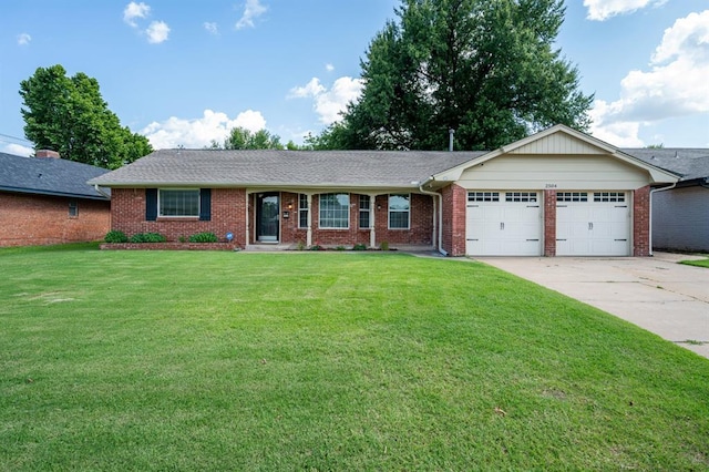 2504 NW 119th St, Oklahoma City, OK 73120 - ranch-style home featuring an attached garage, brick siding, a front lawn, and driveway
