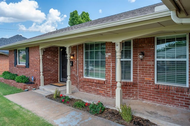 2504 NW 119th St, Oklahoma City, OK 73120 - view of exterior entry featuring brick siding and a shingled roof