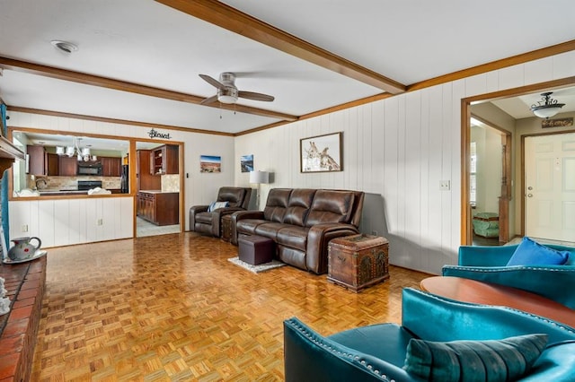 2504 NW 119th St, Oklahoma City, OK 73120 - living room with ceiling fan, a chandelier, beamed ceiling, and wooden walls