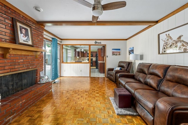 2504 NW 119th St, Oklahoma City, OK 73120 - living area featuring beamed ceiling, ceiling fan, a fireplace, wooden walls, and ornamental molding