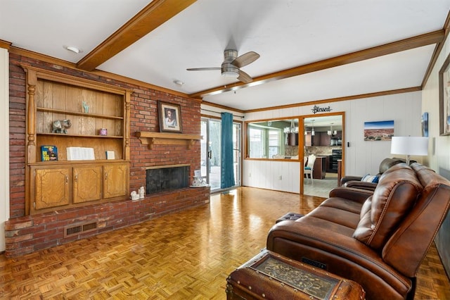 2504 NW 119th St, Oklahoma City, OK 73120 - living area with beam ceiling, a ceiling fan, a fireplace, and wooden walls