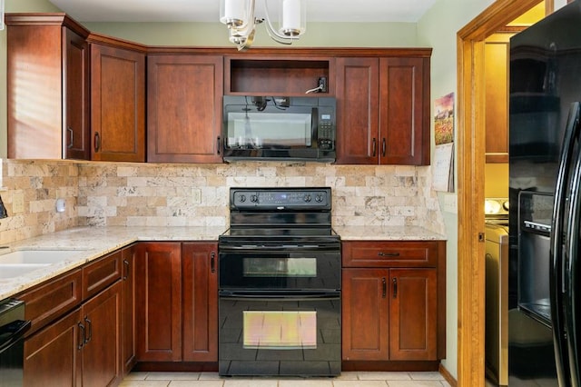 2504 NW 119th St, Oklahoma City, OK 73120 - kitchen featuring black appliances, light stone counters, a chandelier, and tasteful backsplash