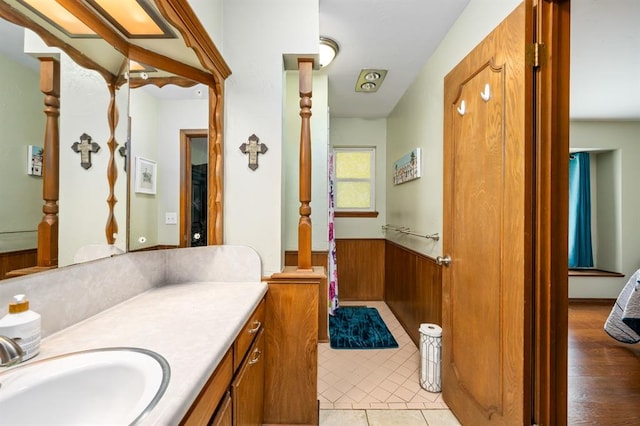 2504 NW 119th St, Oklahoma City, OK 73120 - ensuite bathroom featuring vanity, wainscoting, and wood walls